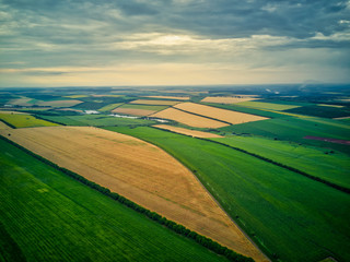 Aerial view of the countryside with village and fields of crops in summer
