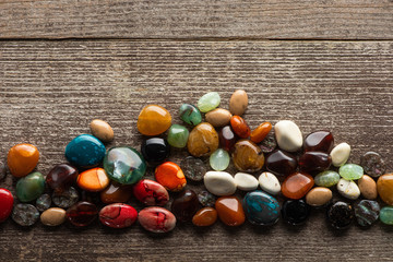 Top view of colorful fortune telling stones on wooden surface