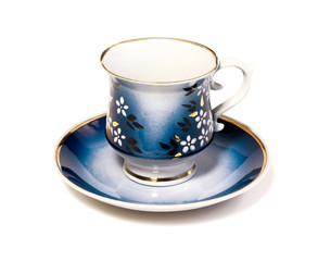 Blue coffee cup with saucer isolated on a white background.