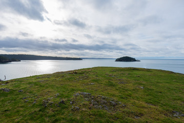 High angle landscape from grassy hill of the Pacific Ocean in Anacortes, Washington