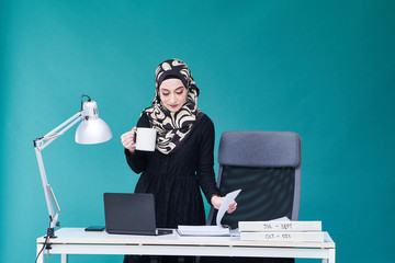 Office Lady with bundle of file on the table and laptop