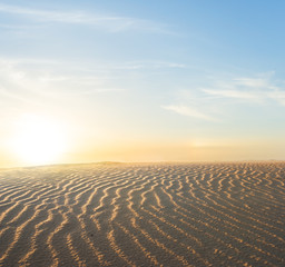 wavy sandy desert  landscape at the sunset