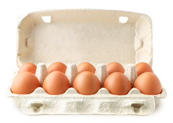 Open tray container of chicken eggs on a white background. Isolated