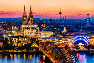 Fototapeta na wymiar Beautiful night landscape of the gothic Cologne cathedral, Hohenzollern Bridge and the River Rhine at sunset and blue hour in Cologne, Germany