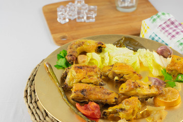 baked chicken pieces on a tray with garnish
