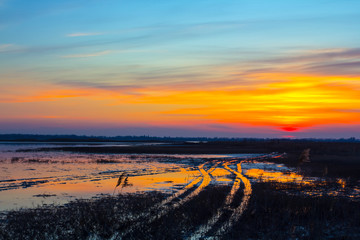 dramatic sunset over the flooded spring fields