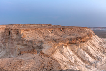 Sunrise over Ustyurt Plateau. District of Boszhir. The bottom of a dry ocean Tethys. Rocky remnants. Kazakhstan. selective focus