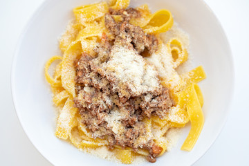 Close up of tasty homemade pasta with bolognese sauce and cheese