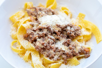 Close up of tasty homemade pasta with bolognese sauce and cheese