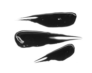 Texture of black crushed eyeliner or black acrylic paint isolated on white background