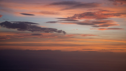 Naklejka na ściany i meble Sunset from airplane with clouds