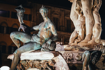 Detail from the Fountain of Neptune statue Piazza della Signoria at night in front of the Palazzo...
