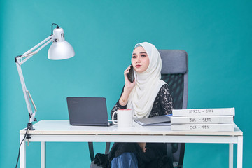 Office Lady with bundle of file on the table and laptop
