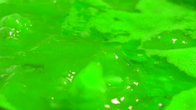 Green liquid boils. Toxic chemical substance. Witch's potion.