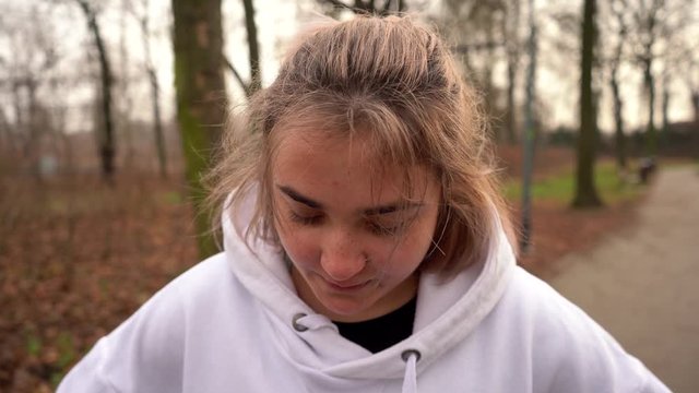 Girl with freckles breathes deeply after running. Breathful girl after sport