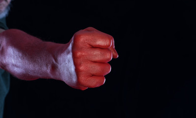 red bloody fist on a black background