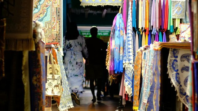 people walking in a vintage blanket shopping street