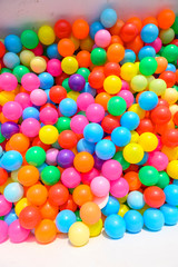 Fototapeta na wymiar Small colorful plastic balls in playground yard