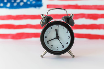 Alarm clock and abstract hand drawn American flag on background. President elections, Memorial Day, 4th of July or Labour Day concept. Learning English grammar tenses. Patriotism and independence.