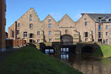 Fototapeta na wymiar s’Hertogenmolens: large water mills on the river Demer in Aarschot (Belgium). Built around 1510. View from the east