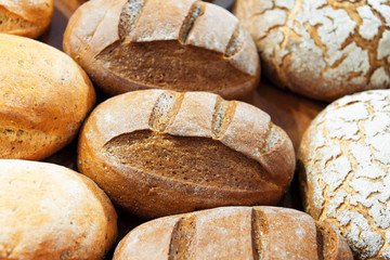 Fresh bread. Several loaves of bread lie on a wooden tray