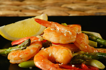 Fried prawns   chili on a black plate. 