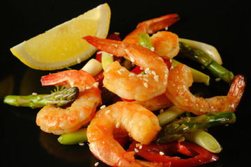 Fried prawns   chili on a black plate. 