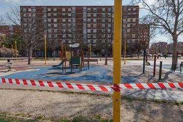 Fototapeta na wymiar PALENCIA, SPAIN - MARCH 13, 2020: closed and empty children playgrounds in Spain because of coronavirus pandemic, covid-19, crisis