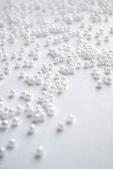 white beads on a white background