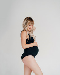 pregnant stand black bodysuit on white background