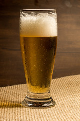glass of beer on a wooden background
