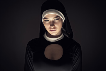 gloomy portrait of a young nun closeup