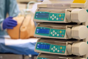 Patient at medication pumps in intensive care is being treated by doctor in hospital	