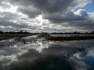 Obraz premium Dramatic cloudy sky over the flooded wetlands, North Yorkshire, England