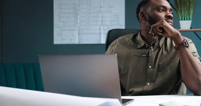 Tired architect working overtime in office. Stressed businessman have financial problems and searching ideas to overcome financial crisis. Entrepreneur in bankruptcy. Burnout and overwork concept.