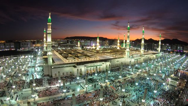 Muslim pilgrims leave and enter the Prophet's mosque in Madina at sunset, religion in Saudi Arabia