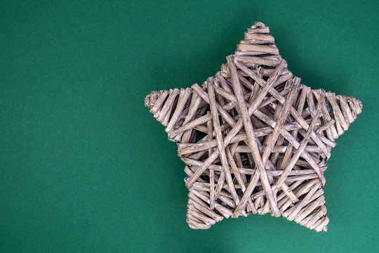 braided rattan star on green background - Powered by Adobe