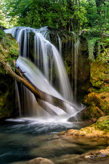 Obraz premium Long exposure of the beautiful La Vaioaga waterfall with green moss, Beusnita, Cheile Nerei National Park, Caras Severin, Romania