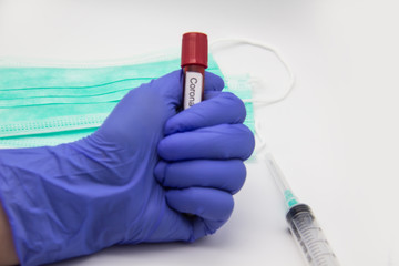 Coronavirus blood test 2019.Coronavirus came from Wuhan, China. Doctor hand in medical glove holding test tube with Coronavirus positive blood in laboratory. Concept can be used in the design