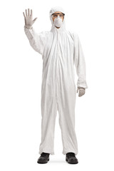 Full length portrait of a man wearing a decontamination suit and gesturing stop
