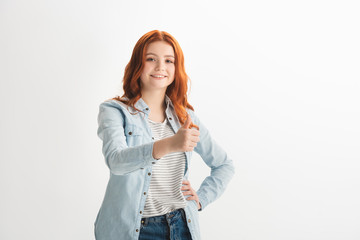 smiling redhead female teenager showing thumb up, isolated on white