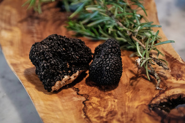 black truffle on rustic wooden tray