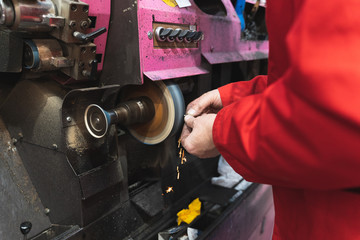 Shoemaker working with a machine with an electric disk