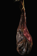 Dry Spanish ham, Jamon Serrano, Bellota, Italian Prosciutto Crudo or Parma ham, whole leg isolated on black background