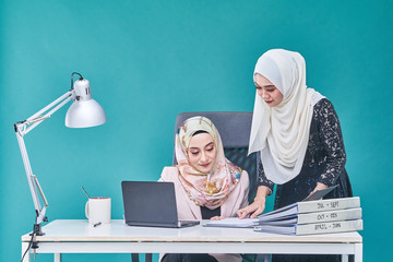 Office Lady with bundle of file on the table and laptop