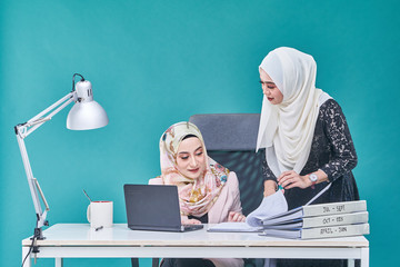 Office Lady with bundle of file on the table and laptop