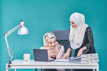 Office Lady with bundle of file on the table and laptop