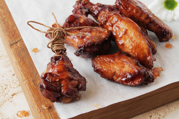  fried chicken wings with the addition of soy sauce and chili, aesthetically laid out on a marble table