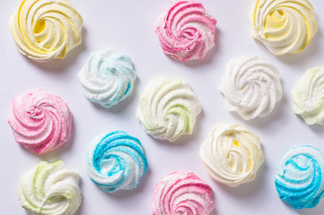 Homemade sweet colored meringue on white background.  .Dessert.