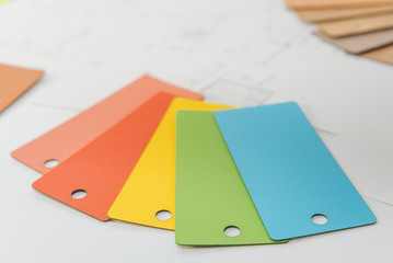 a set of color sample cards on a light background. color plates with the texture of different products. top view for color and material selection
